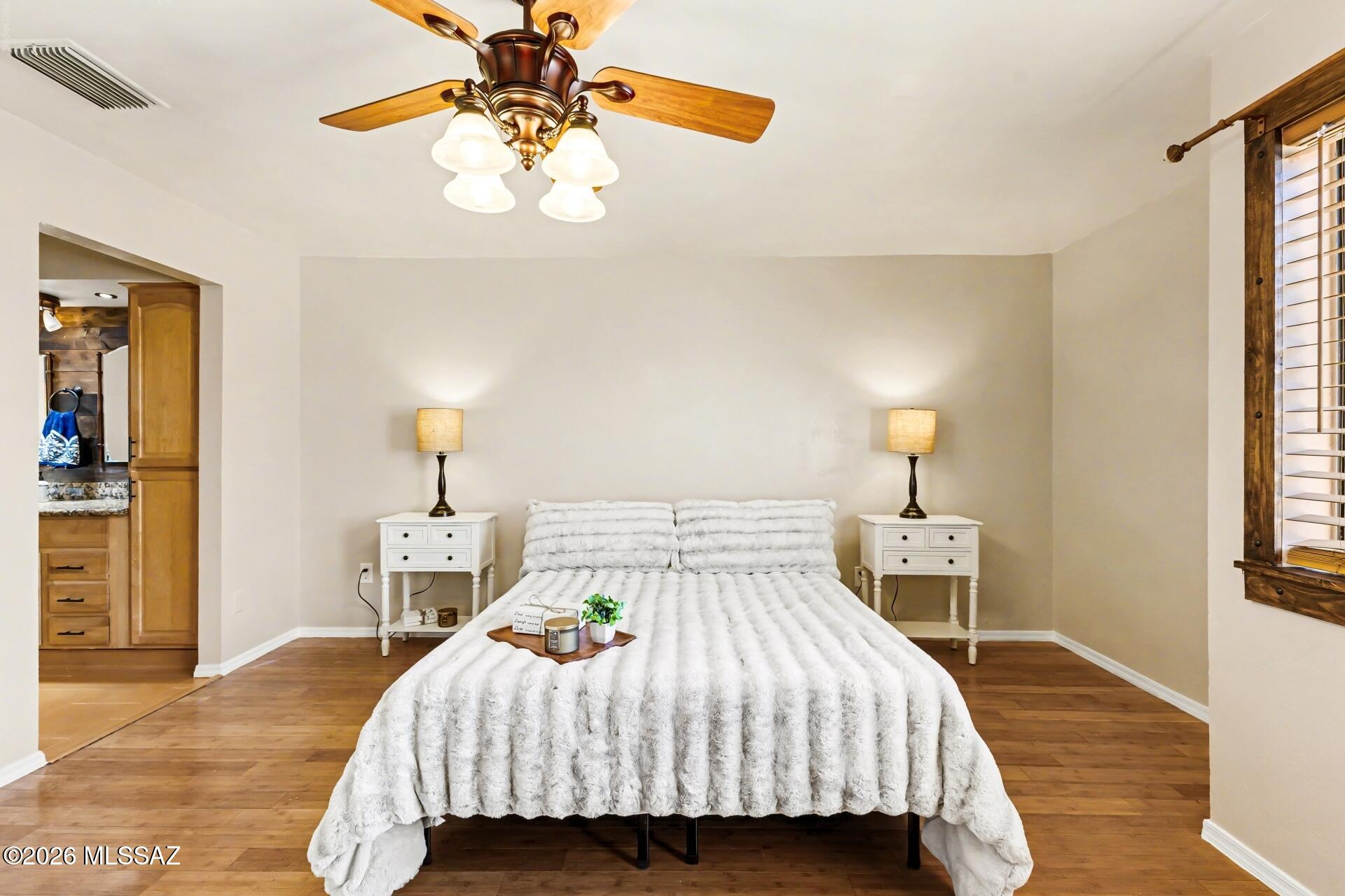 3781 East Edison Street Tucson, AZ 85716 - Photo 14 of 28 a bedroom with a bed and wooden floor