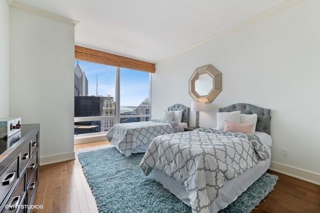 a bed room with two bed and a television