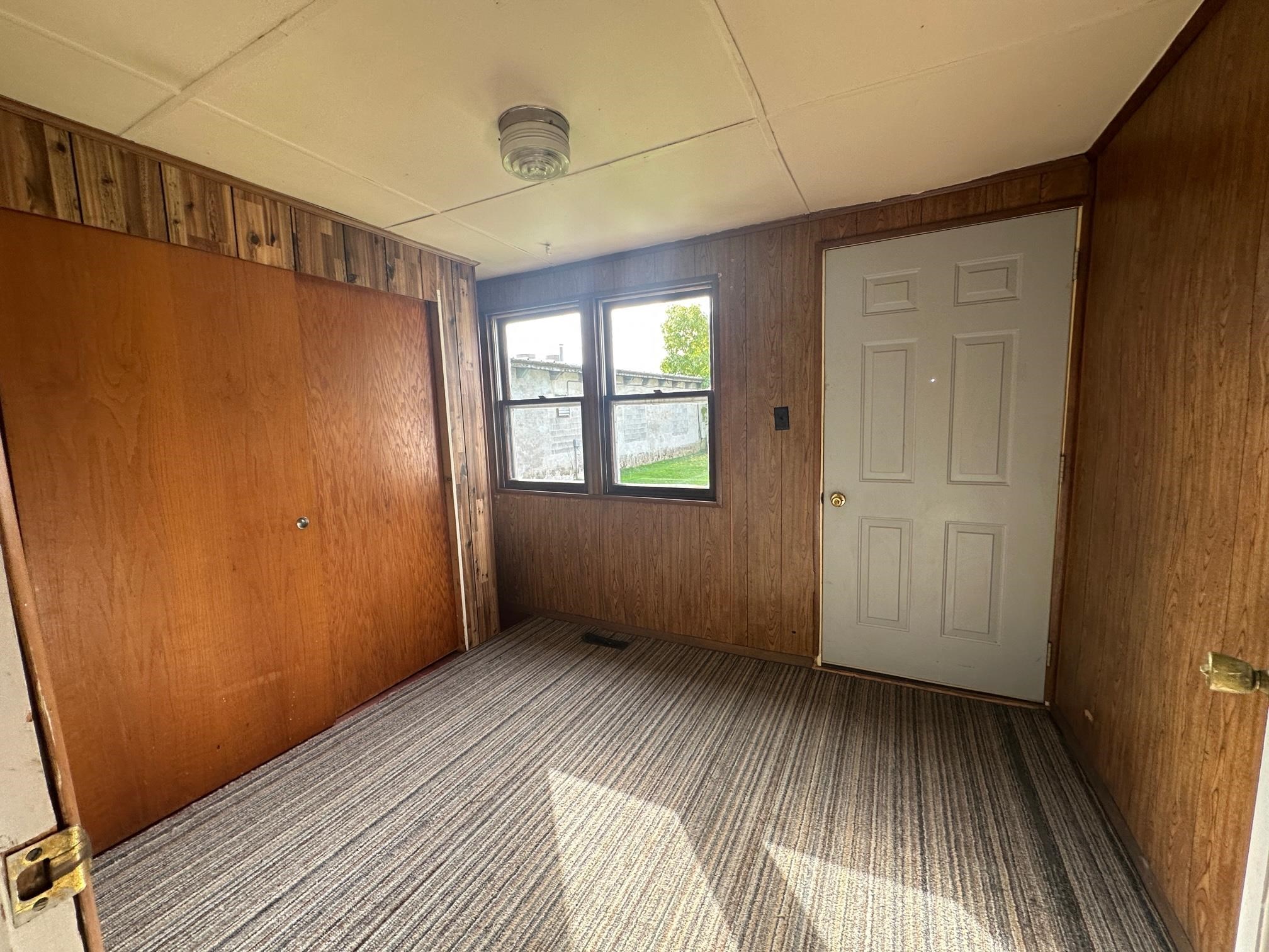 6 Garfield Road Harvard, IL 60033 - Photo 12 of 14 a view of an empty room with wooden floor and a window