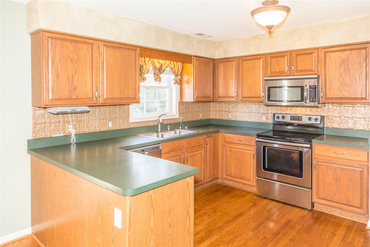 58 Long Bow Road Waynesboro, VA 22980 - Photo 19 of 42 a kitchen with stainless steel appliances granite countertop a stove a sink and a microwave
