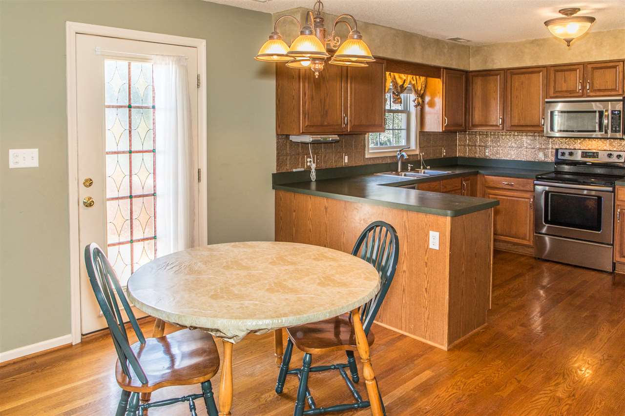 58 Long Bow Road Waynesboro, VA 22980 - Photo 20 of 42 a dining room with a table chairs and a kitchen view
