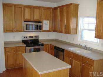 206 Pilot Court Knightdale, NC 27545 - Photo 3 of 5 a kitchen with a sink a stove and cabinets