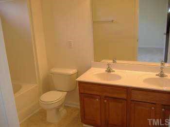 206 Pilot Court Knightdale, NC 27545 - Photo 5 of 5 a bathroom with a sink a toilet and a mirror