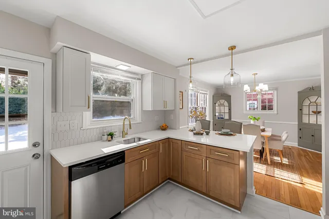 a kitchen with a sink appliances and cabinets