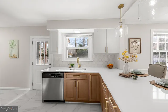 a kitchen with stainless steel appliances a sink stove and refrigerator