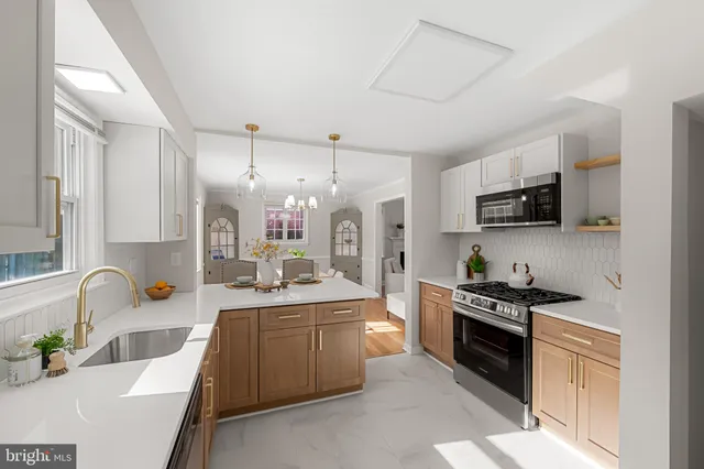 a kitchen with stainless steel appliances granite countertop a sink and a window