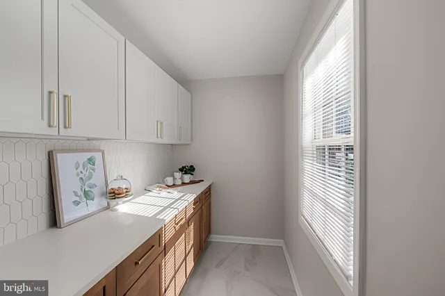 a bedroom with a bed and painting on the wall