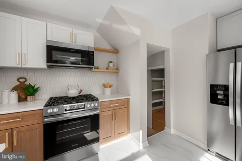 a view of a room with shelves on the wall