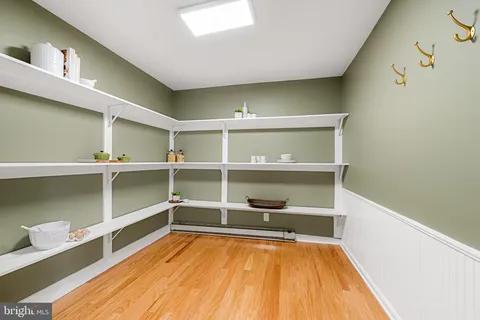 a spacious bedroom with a bed and a chandelier