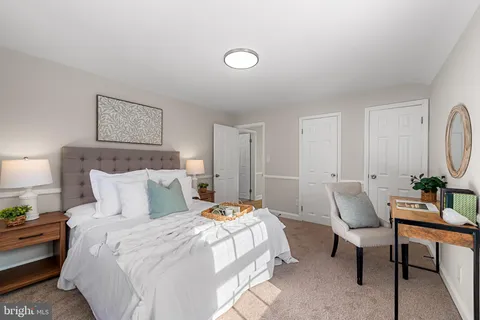 a bed room with a bed and a painting on the wall