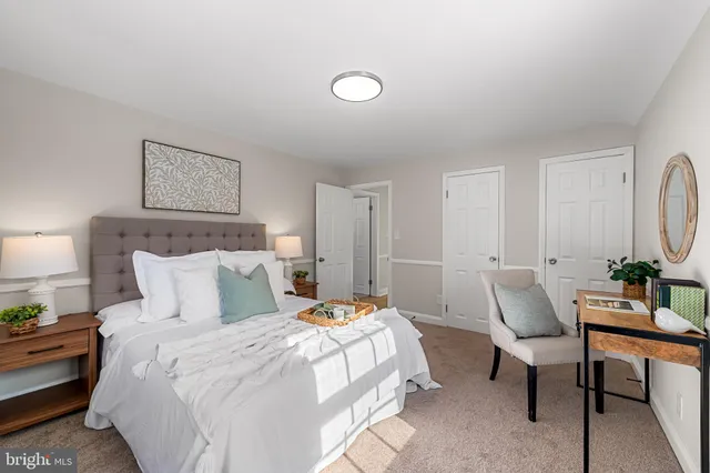 a bed room with a bed and a painting on the wall