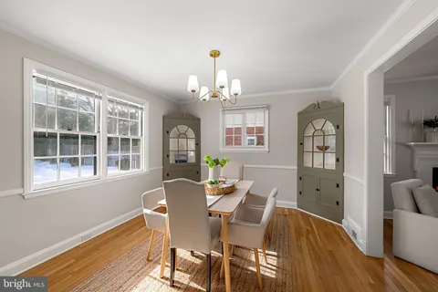 a living room with furniture chandelier and a window