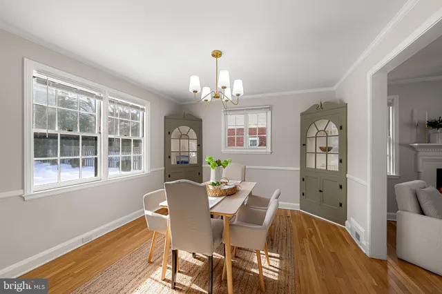 a living room with furniture chandelier and a window