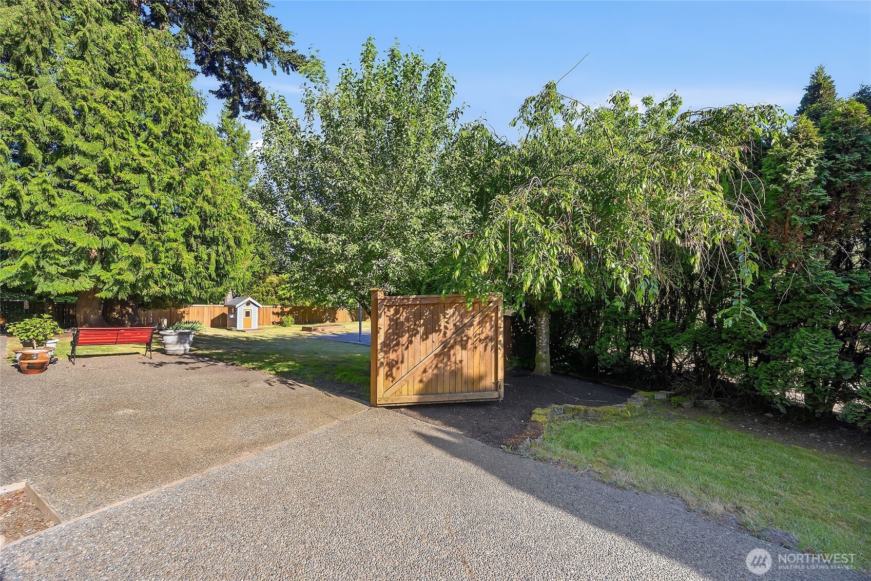 23707 Meridian Place West Bothell, WA 98021 - Photo 37 of 40 a view of a street with potted plants and large trees