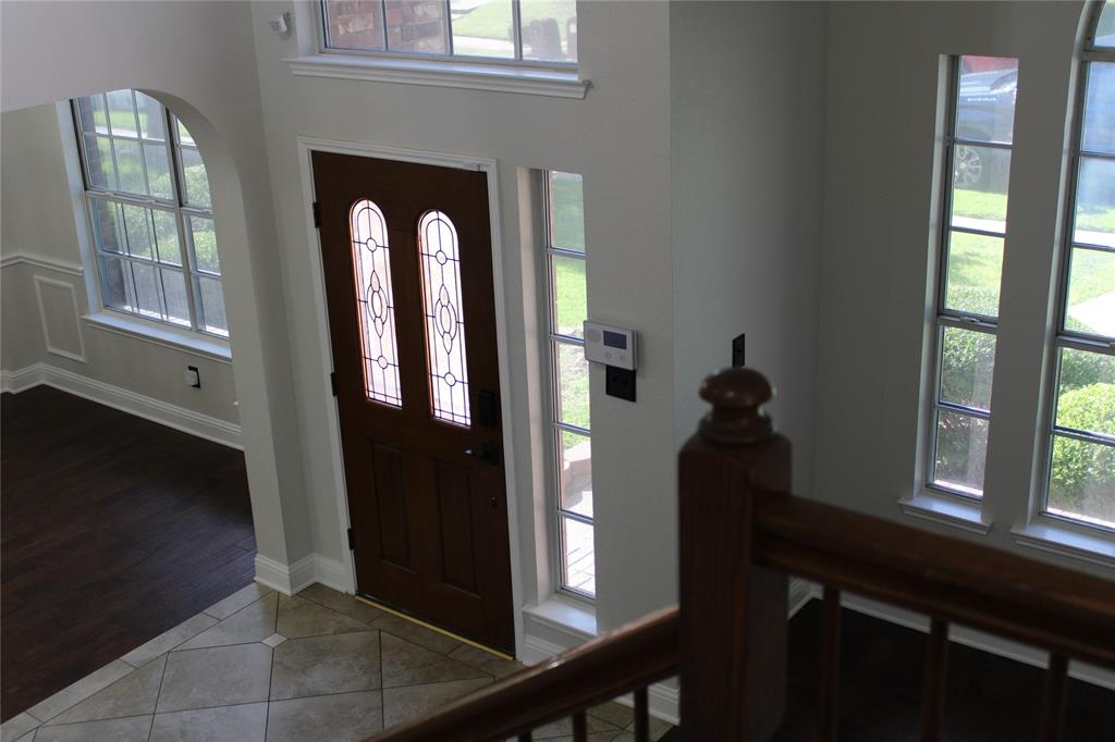 8905 Lakepointe Avenue Rowlett, TX 75088 - Photo 7 of 27 Tiled entryway featuring healthy amount of natural light and arched walkways