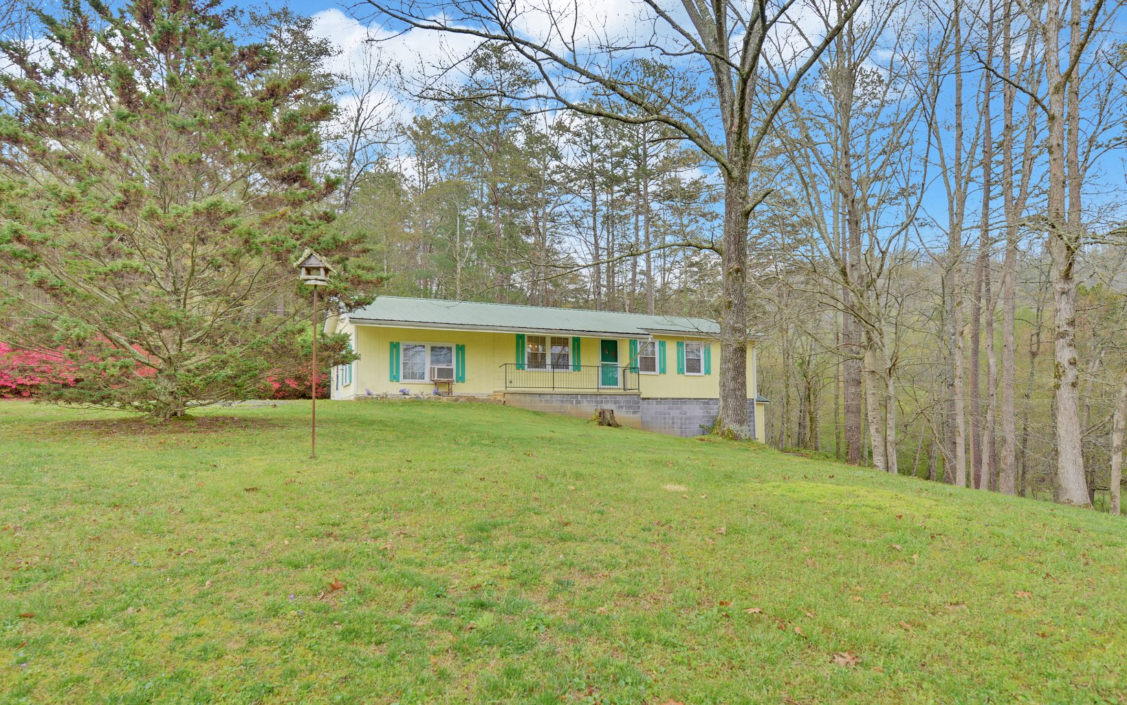 a front view of a house with a garden