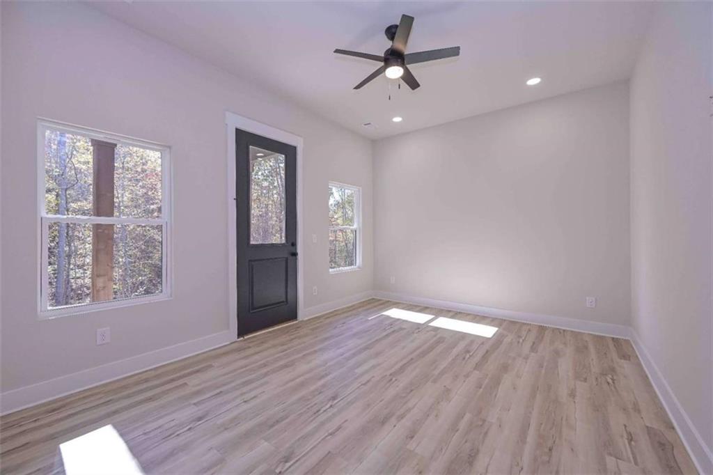 80 Rosemary Way Buchanan, GA 30113 - Photo 12 of 20 a view of an empty room with wooden floor and a window