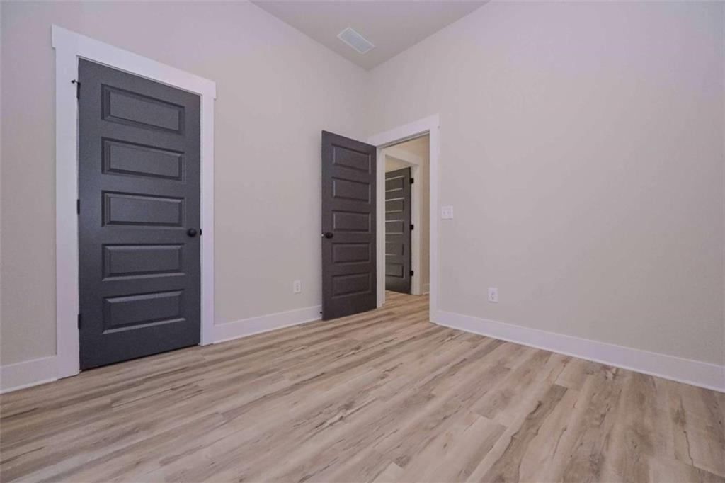 80 Rosemary Way Buchanan, GA 30113 - Photo 19 of 20 a view of an empty room with a fireplace and wooden floor