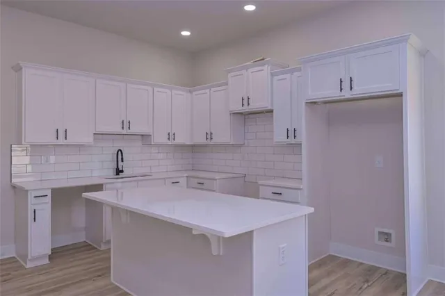 a kitchen with kitchen island a sink dishwasher and a large refrigerator