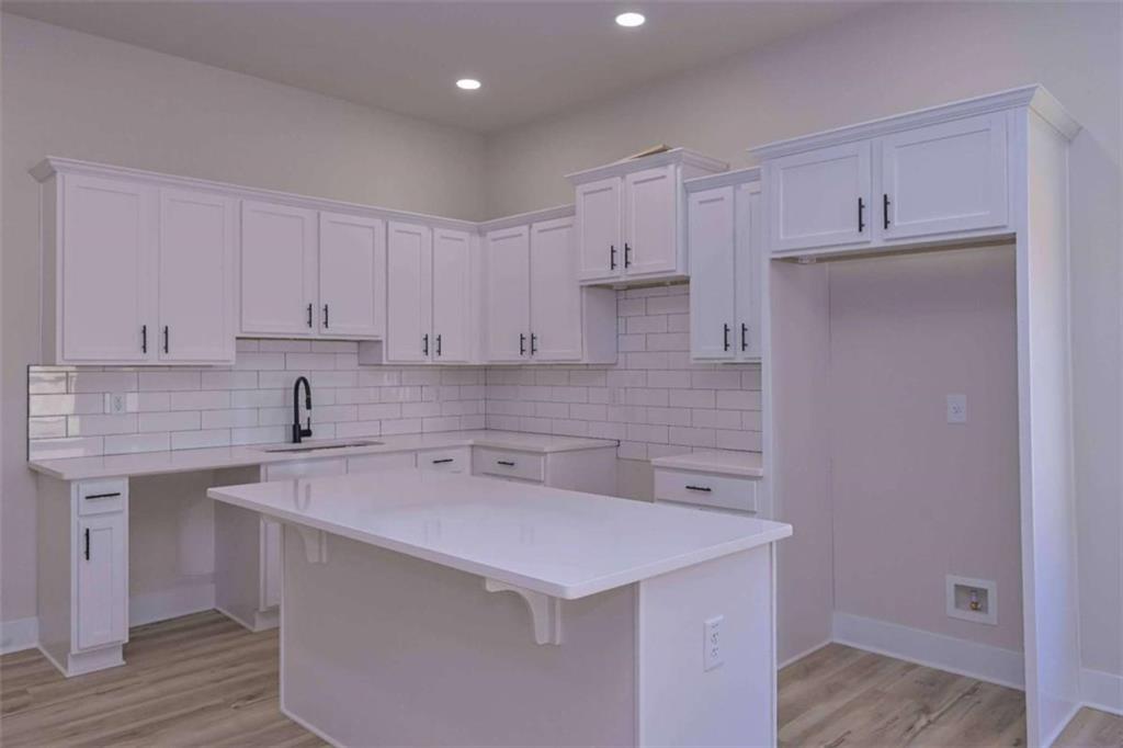 80 Rosemary Way Buchanan, GA 30113 - Photo 9 of 20 a kitchen with a sink a stove and cabinets