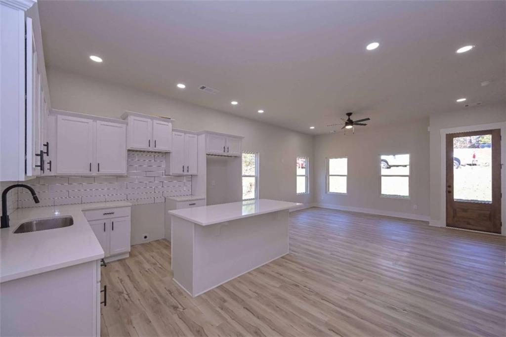 80 Rosemary Way Buchanan, GA 30113 - Photo 10 of 20 a large kitchen with stainless steel appliances granite countertop a large center island attached withe living room