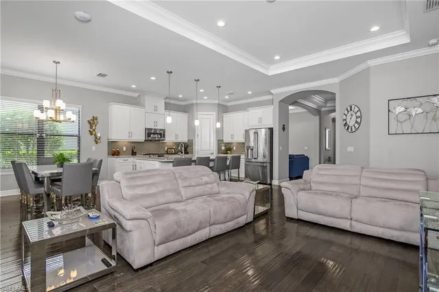 a living room with furniture and a dining table