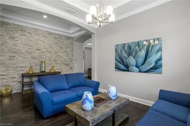 a living room with furniture a couch and a chandelier