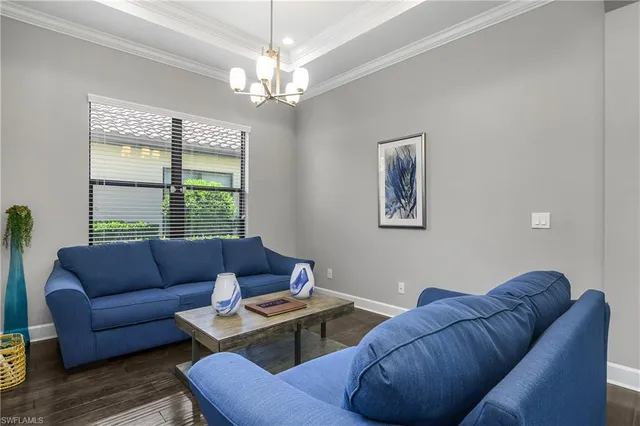 a living room with furniture and a chandelier