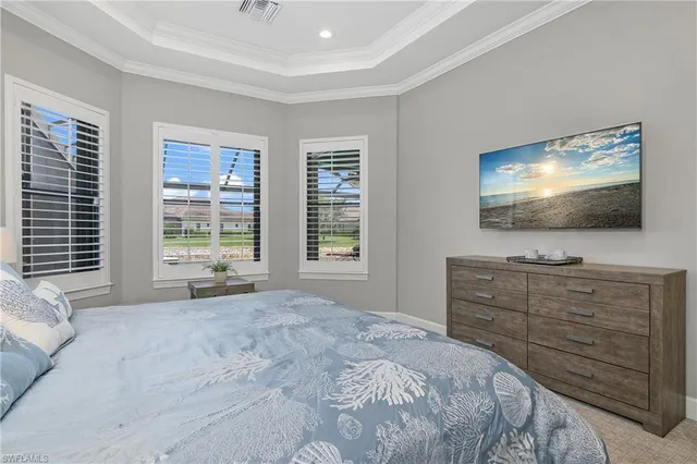 a bedroom with a bed and a flat screen tv in it