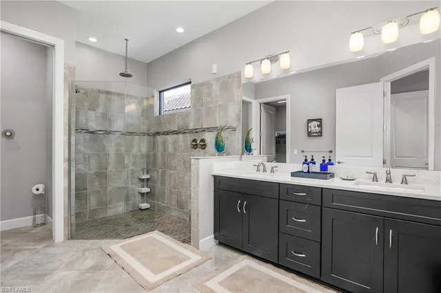 a bathroom with a double vanity sink mirror and shower