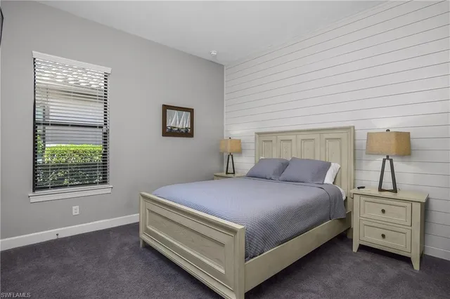 a bedroom with a bed and a night stand