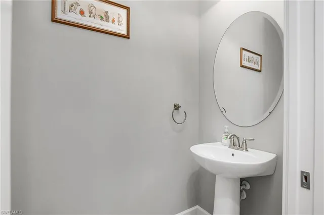 a bathroom with a sink and mirror