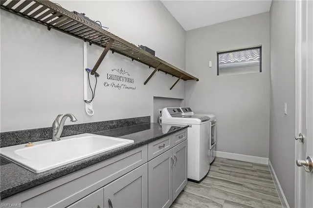 a utility room with sink dryer and washer