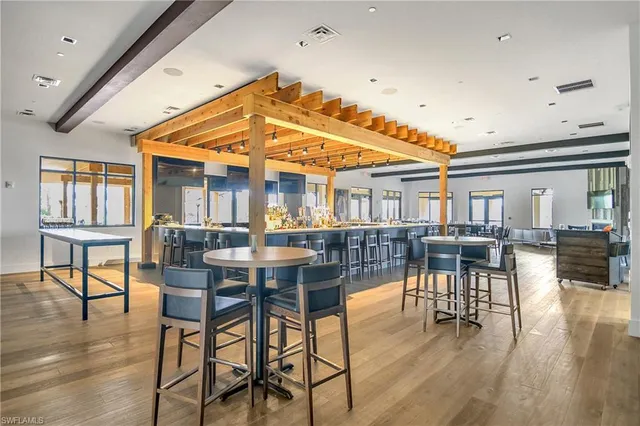 a dining room with furniture a rug and wooden floor