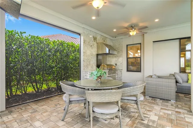 a dining room with furniture and a floor to ceiling window
