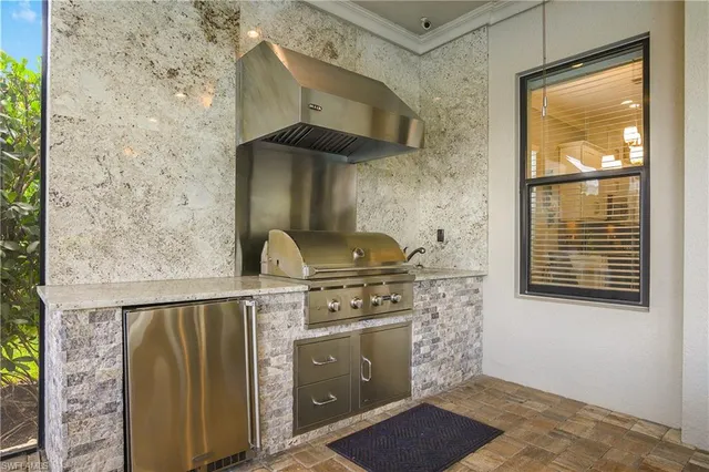a kitchen with a stove and a window