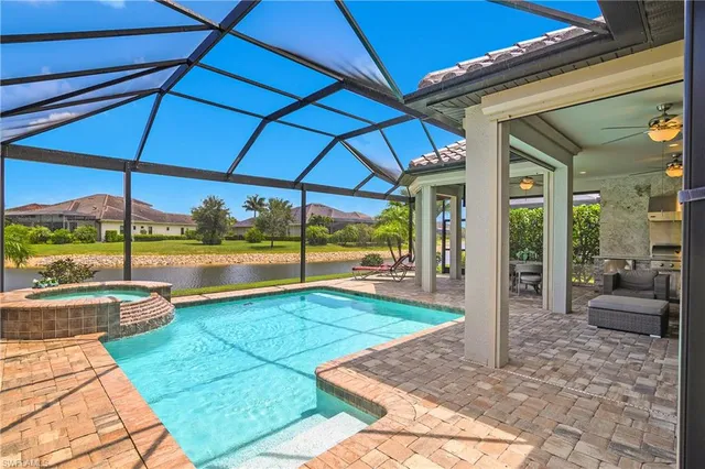 a view of a patio with table and chairs under an umbrella