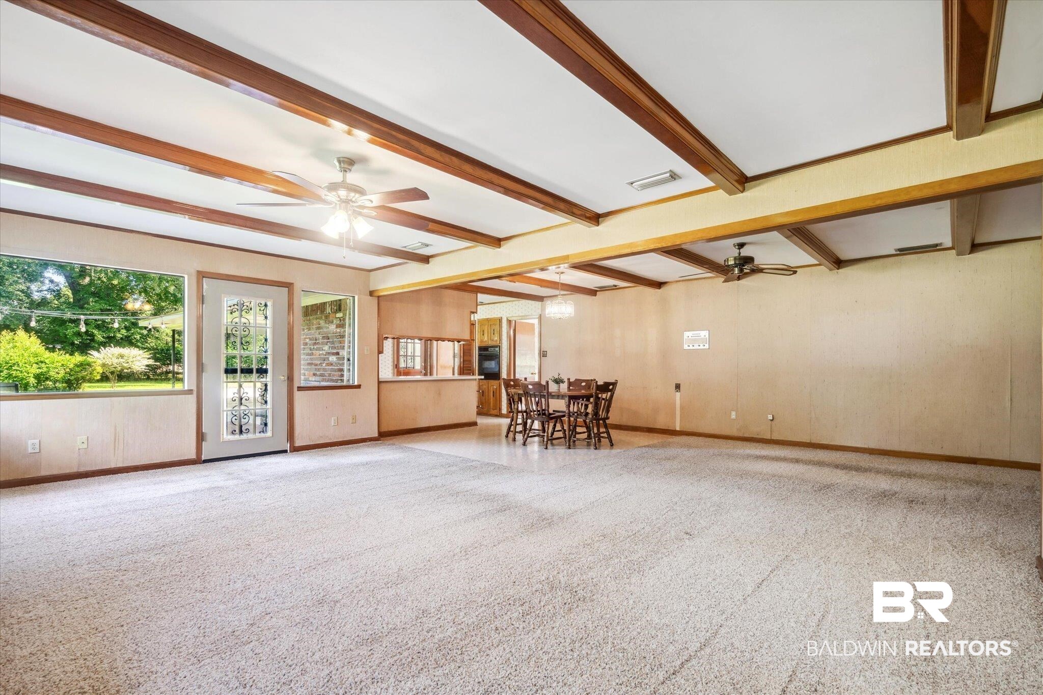 1252 Helm Circle Mobile, AL 36693 - Photo 8 of 18 Interior space featuring light colored carpet, ceiling fan, and beam ceiling