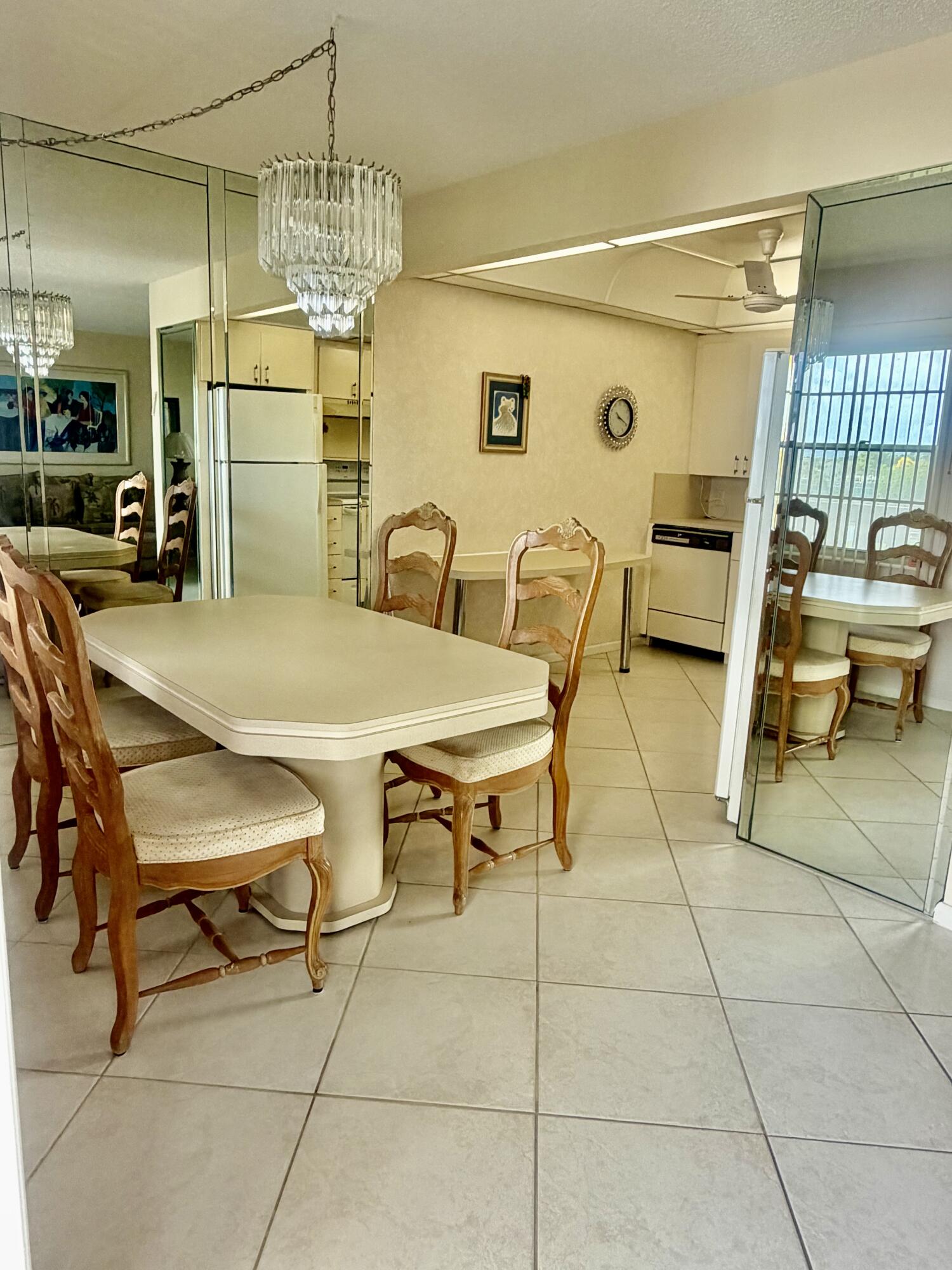 3035 Rexford A Boca Raton, FL 33434 - Photo 4 of 8 a view of a dining room with furniture and a chandelier