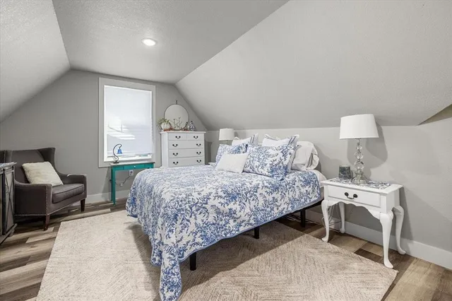 a bed room with a bed and a chair