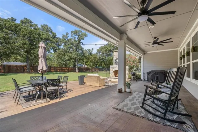 a view of a patio with a dining table and chairs