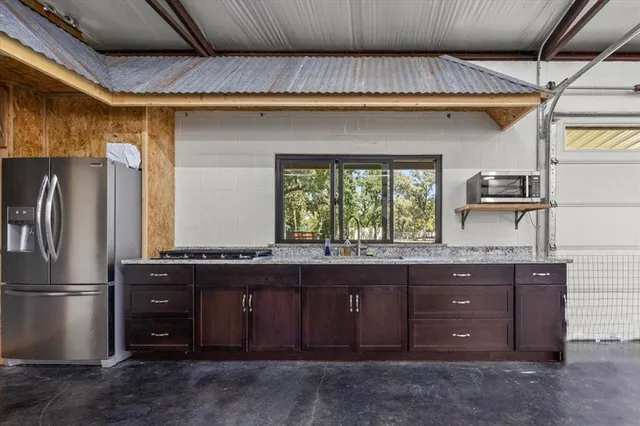 a kitchen with a refrigerator and a sink