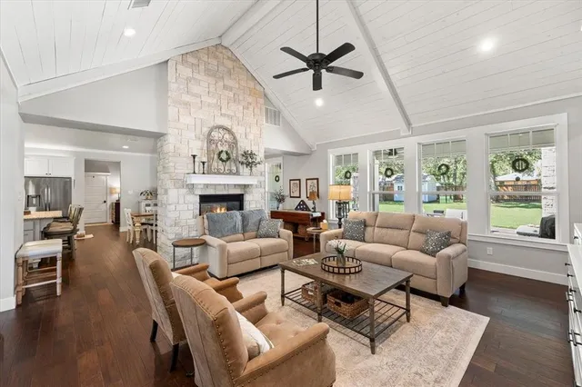 a living room with furniture a fireplace and a chandelier