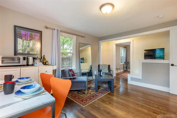 a living room with furniture a flat screen tv and a large window