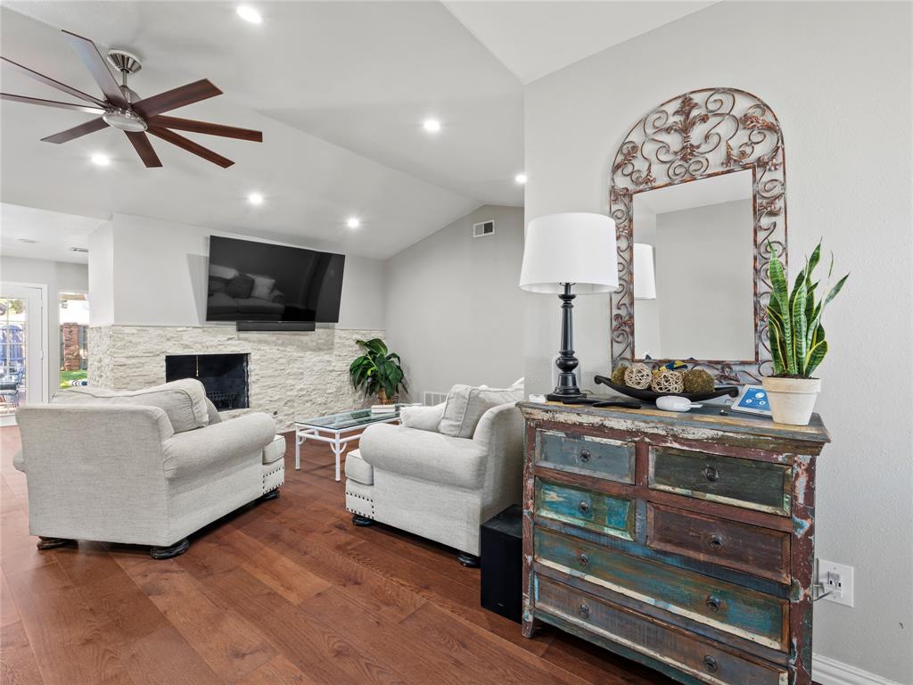 4707 Harvest Hill Road Dallas, TX 75244 - Photo 4 of 20 a living room with furniture fireplace and a flat screen tv