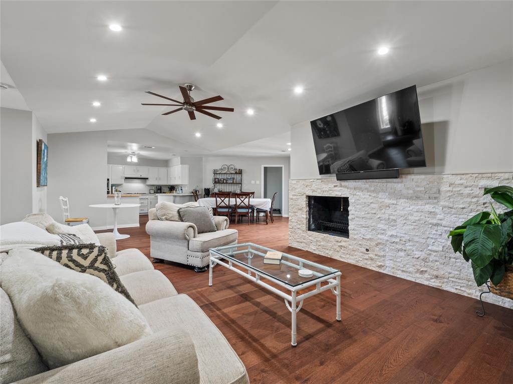 4707 Harvest Hill Road Dallas, TX 75244 - Photo 6 of 20 a living room with fireplace furniture and a flat screen tv