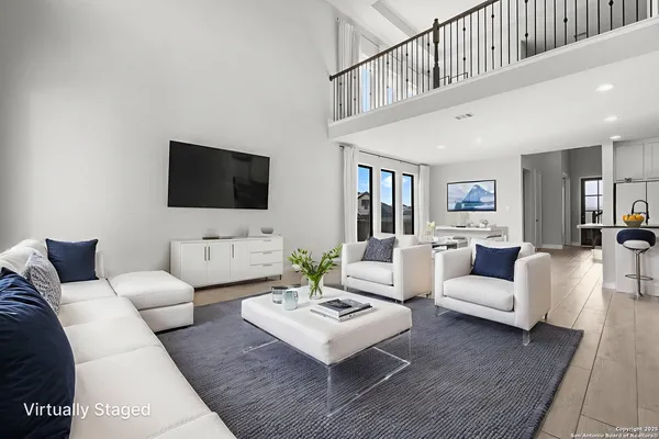 a living room with furniture a rug and a flat screen tv