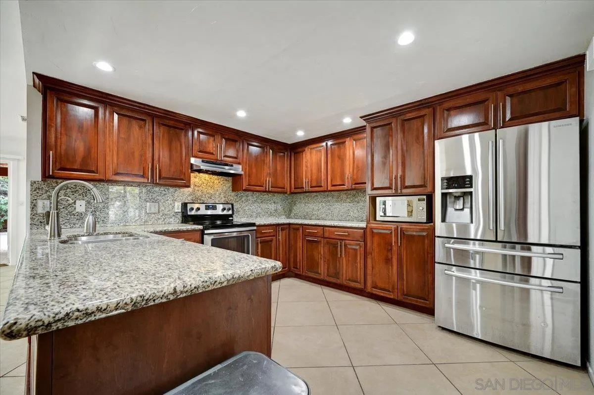 27335 Ventan Street Menifee, CA 92586 - Photo 11 of 36 a kitchen with stainless steel appliances granite countertop a refrigerator sink and cabinets