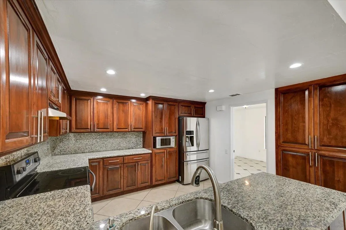 27335 Ventan Street Menifee, CA 92586 - Photo 12 of 36 a kitchen with stainless steel appliances granite countertop a refrigerator and a sink