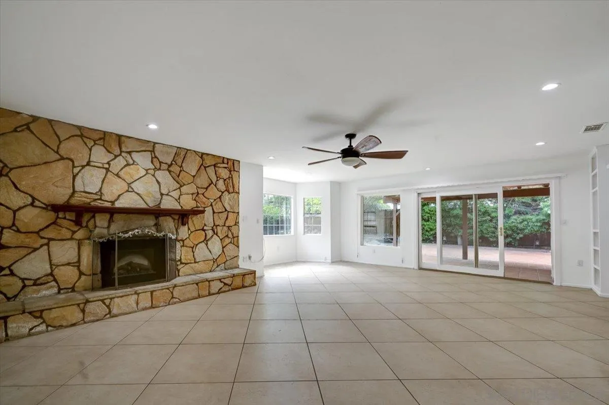 27335 Ventan Street Menifee, CA 92586 - Photo 13 of 36 a view of an empty room with a fireplace and a floor to ceiling window